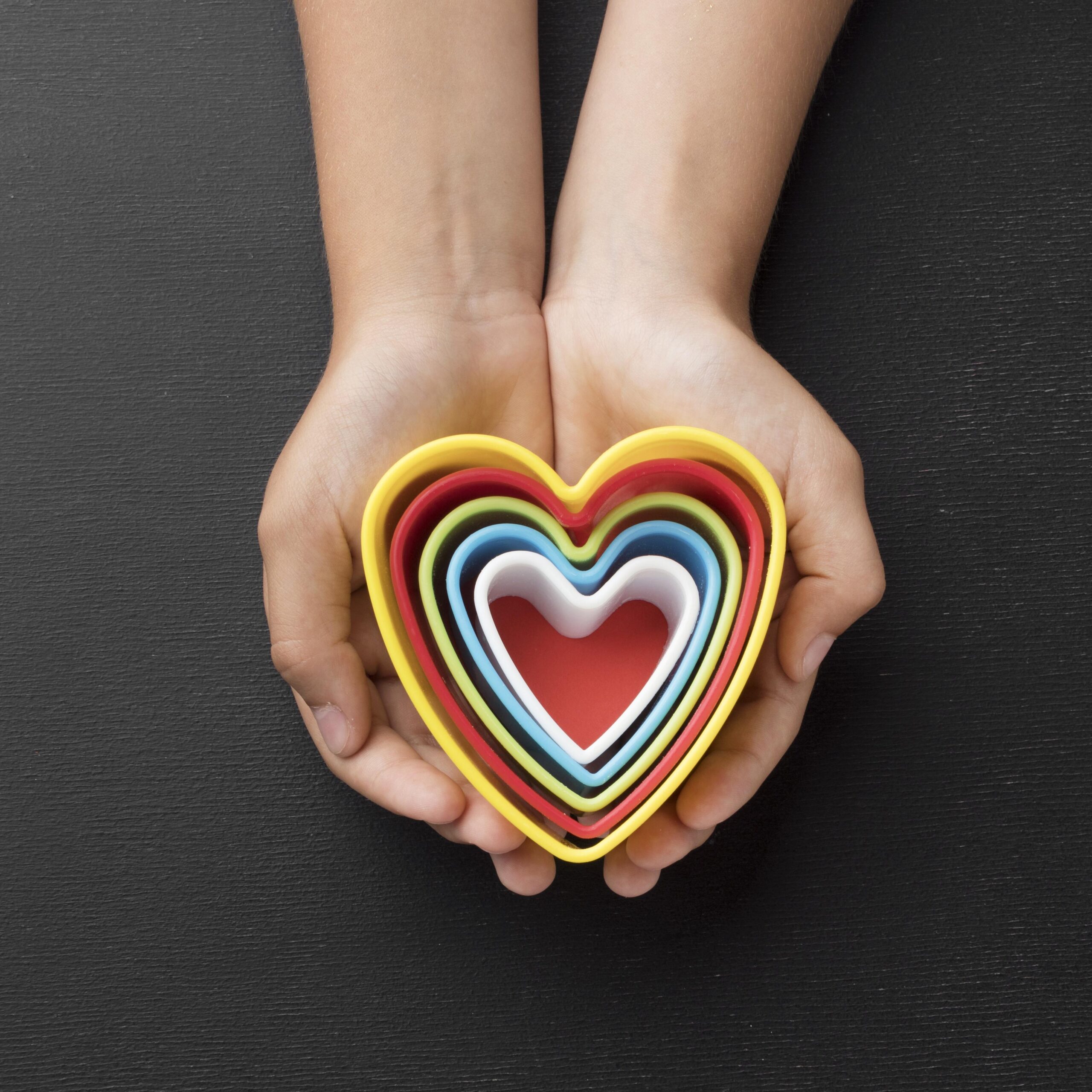 top-view-hands-holding-elements-shape-hearts
